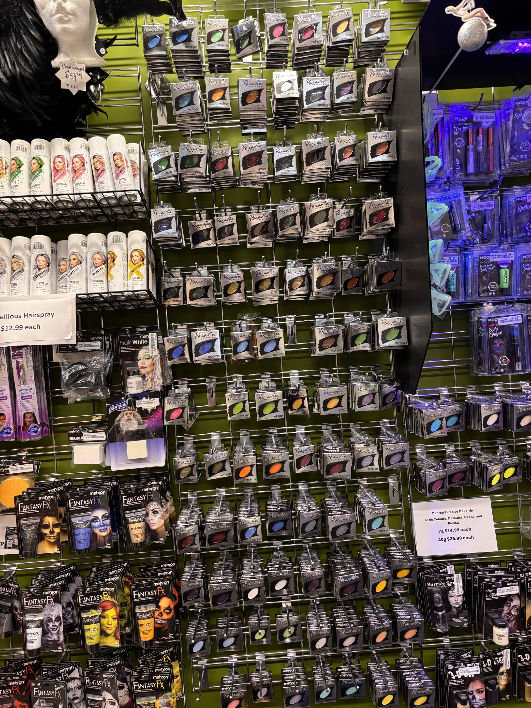Wall of Mehron theatrical makeup and Moon Glow blacklight and glow-in-the-dark makeup at The Costume Shoppe in Calgary