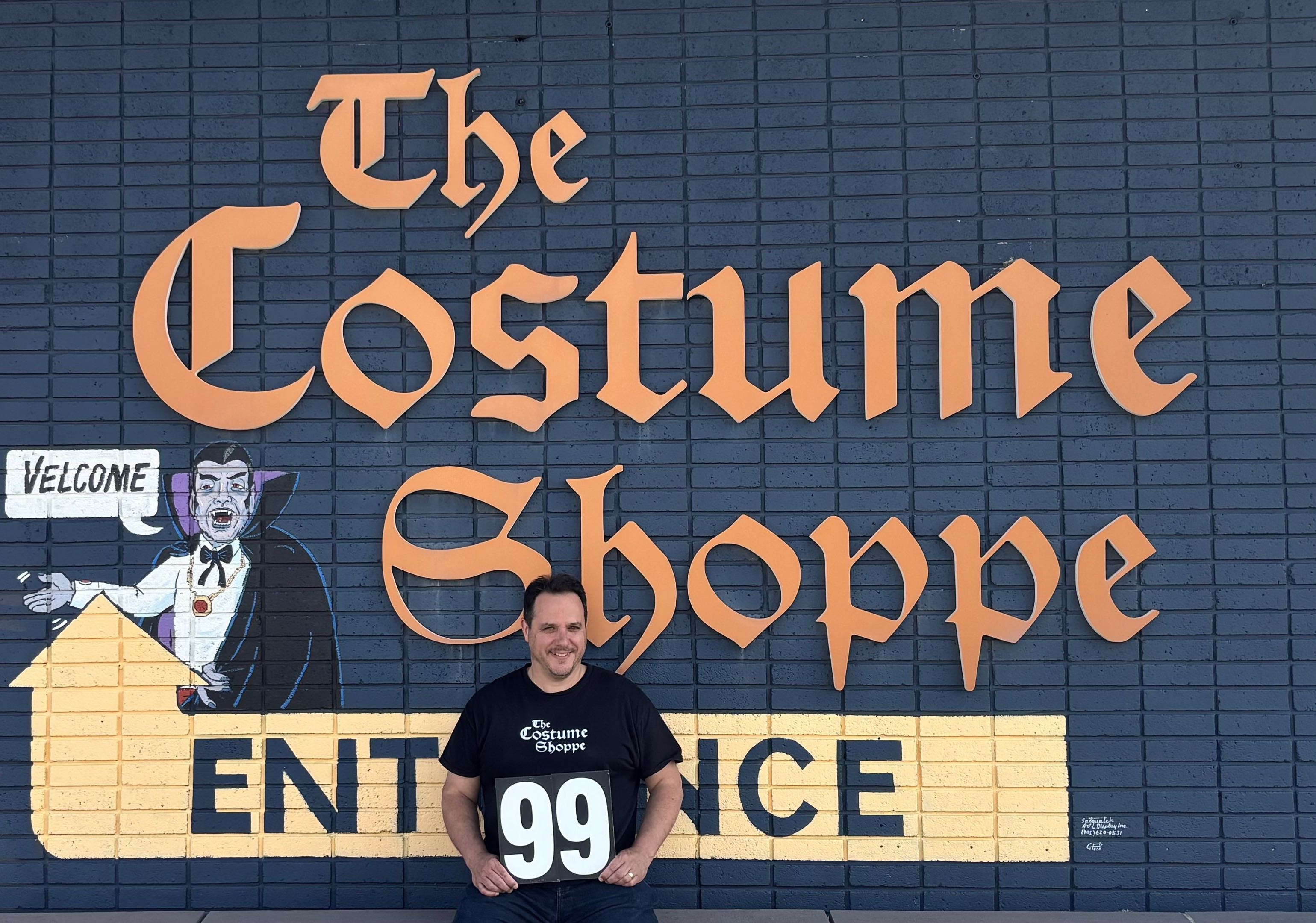 Ry, The Costume Shoppe Guy, celebrating 99 years of trick or treat at the entrance mural, 4307 Blackfoot Trail SE, Calgary